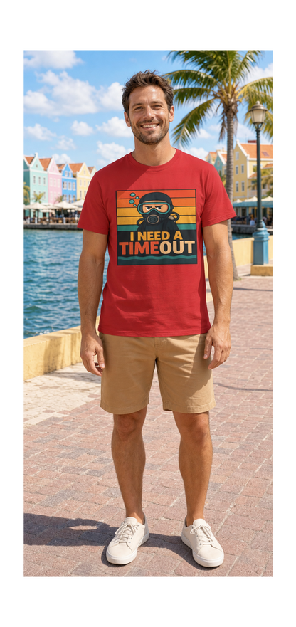 A man wearing a red graphic t-shirt with a retro design that reads 'I NEED A TIMEOUT' and a cartoon character, paired with khaki shorts and white sneakers, standing on a sunny waterfront promenade.